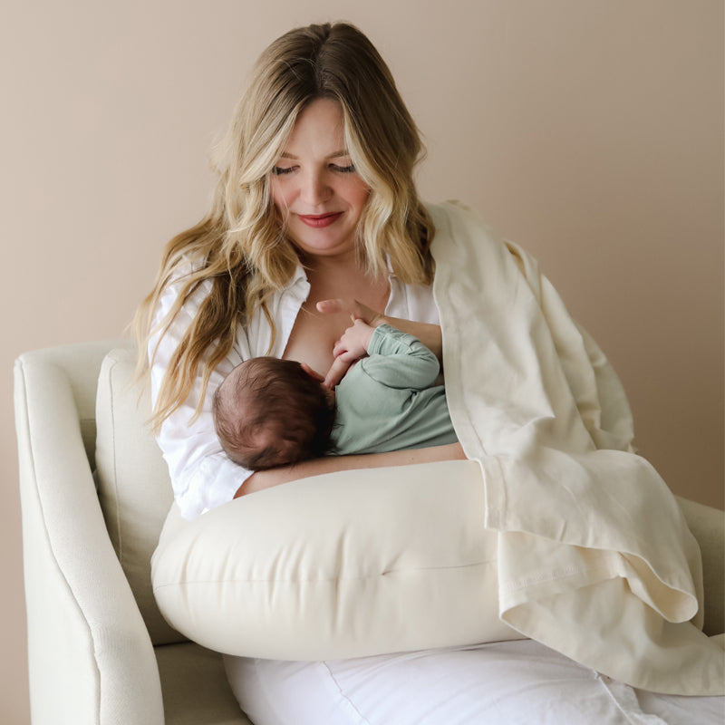 newborn baby breastfeeding on snuggle me organic feeding support nursing pillow natural
