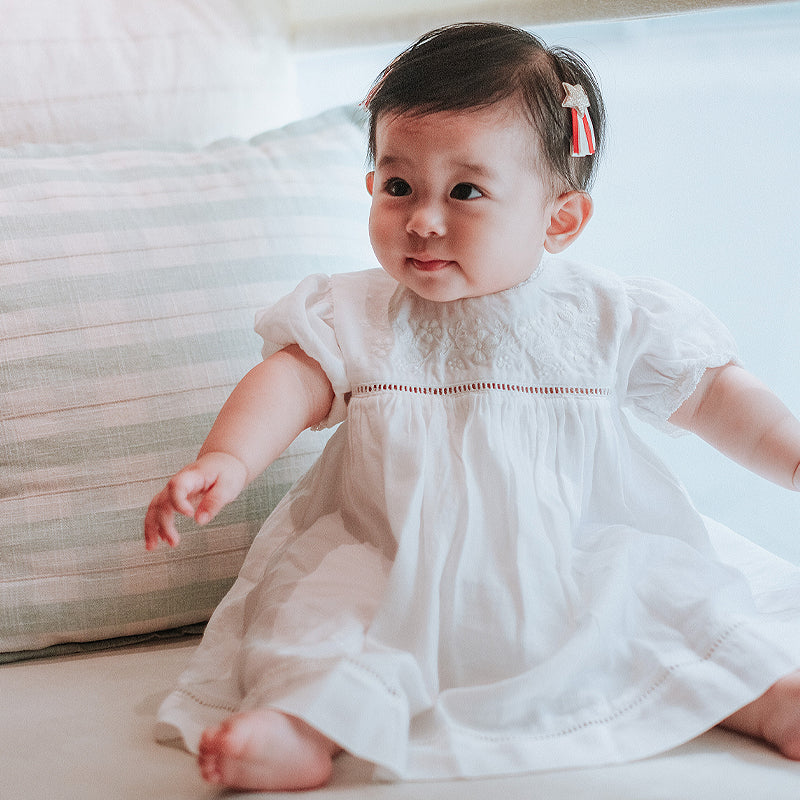 baby elsie wearing purebaby organic embroidered dress vanilla special occasion organic cotton clothes