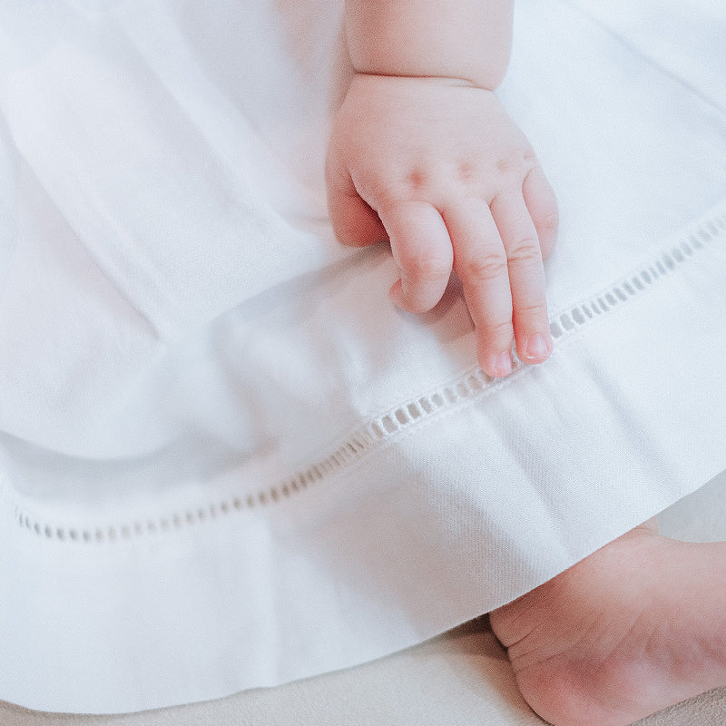 baby elsie wearing purebaby organic embroidered dress vanilla special occasion organic cotton clothes