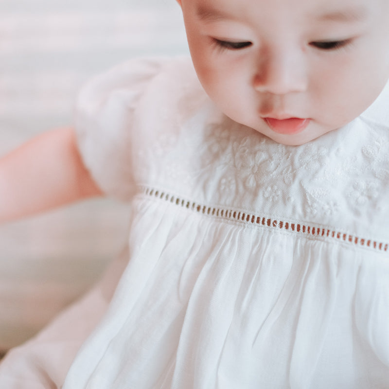 baby elsie wearing purebaby organic embroidered dress vanilla special occasion organic cotton clothes