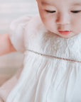 baby elsie wearing purebaby organic embroidered dress vanilla special occasion organic cotton clothes