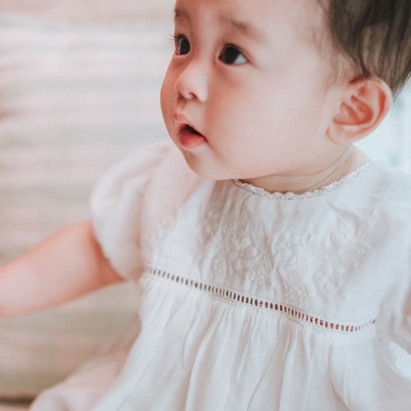 baby elsie wearing purebaby organic embroidered dress vanilla special occasion organic cotton clothes