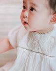 baby elsie wearing purebaby organic embroidered dress vanilla special occasion organic cotton clothes