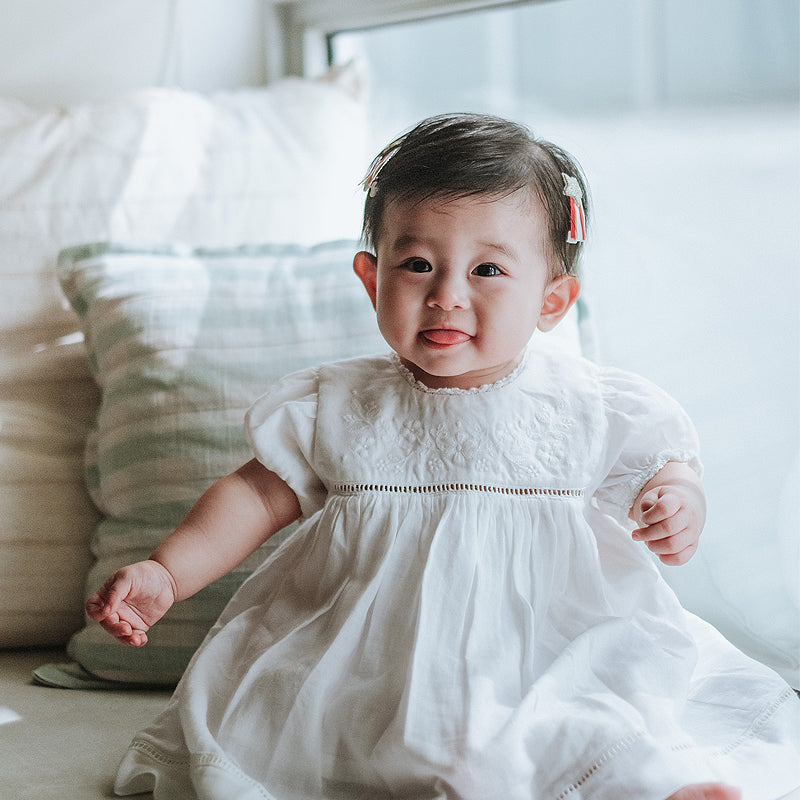 baby elsie wearing purebaby organic embroidered dress vanilla special occasion organic cotton clothes