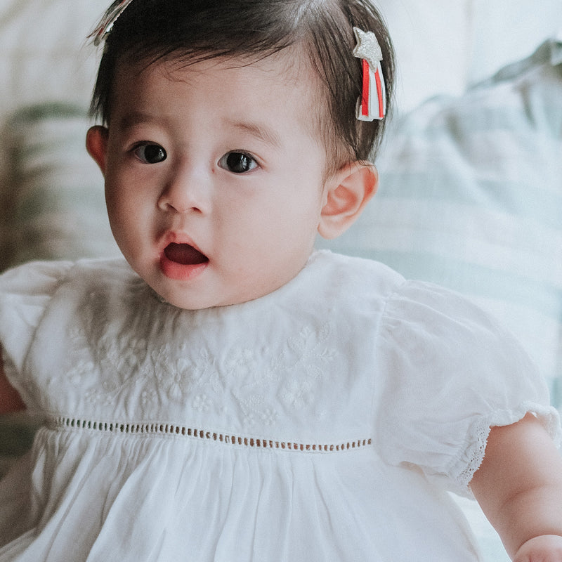 baby elsie wearing purebaby organic embroidered dress vanilla special occasion organic cotton clothes