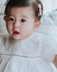 baby elsie wearing purebaby organic embroidered dress vanilla special occasion organic cotton clothes