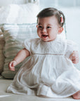 baby elsie wearing purebaby organic embroidered dress vanilla special occasion organic cotton clothes