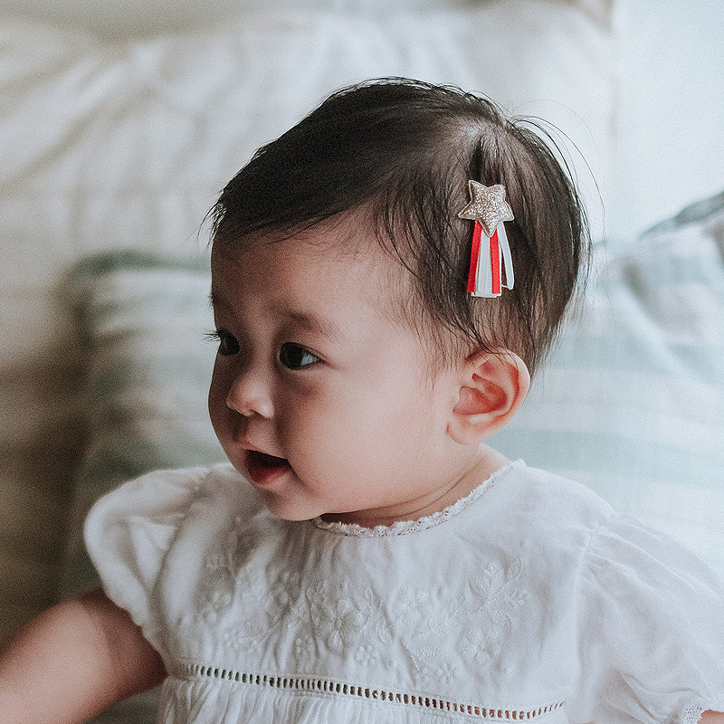 baby elsie wearing purebaby organic christmas hair bow clip