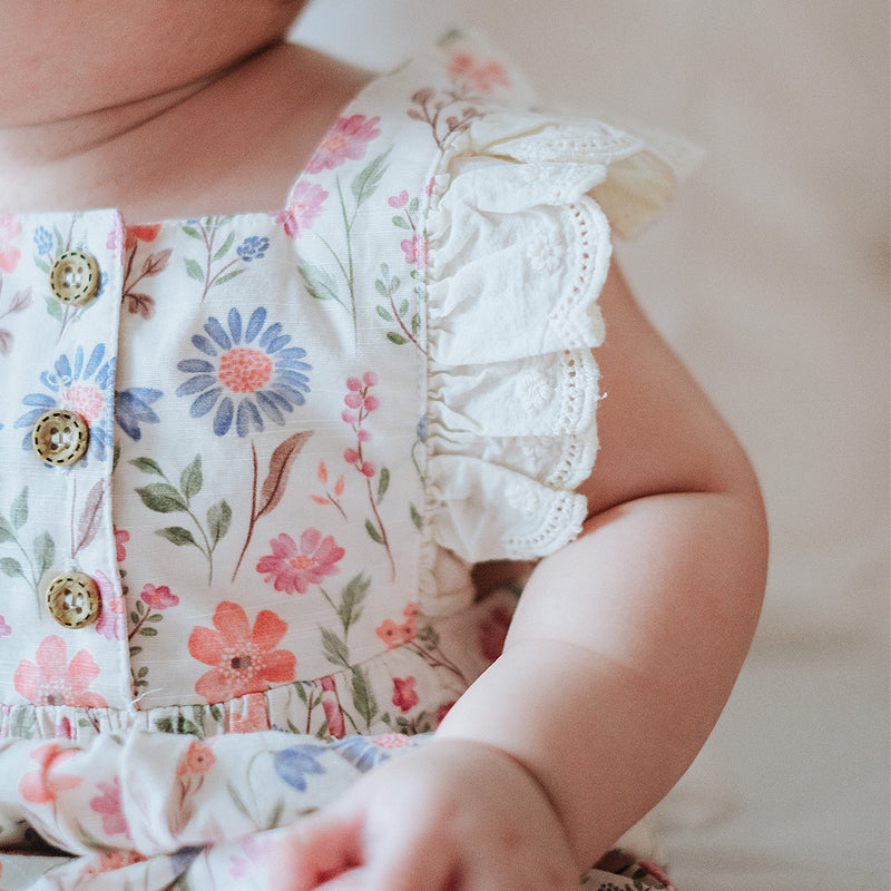 baby elsie wearing purebaby organic geranium floral romper organic cotton baby clothes