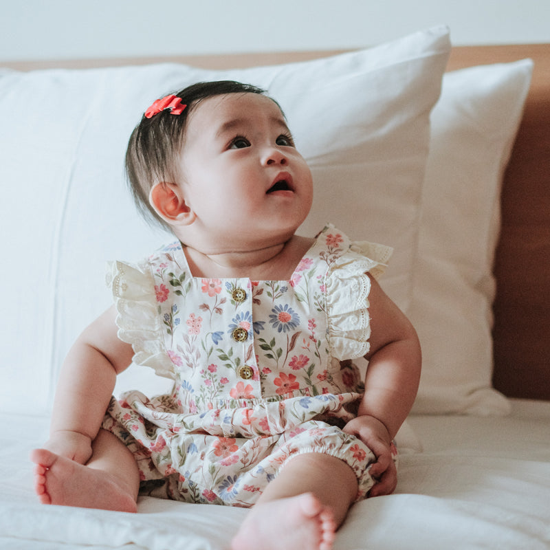 baby elsie wearing purebaby organic geranium floral romper organic cotton baby clothes