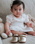 baby elsie wearing purebaby organic mary jane gold pre-walker baby shoes