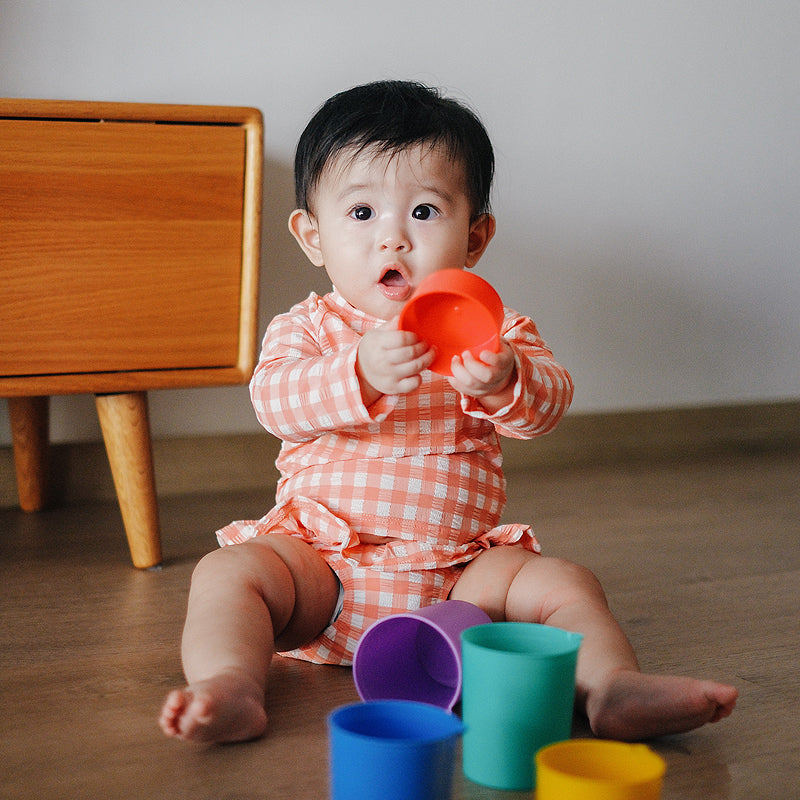 baby elsie wearing purebaby organic red coral gingham baby swimwear