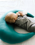 baby drinking milk with milk bottle on snuggle me organic feeding support pillow